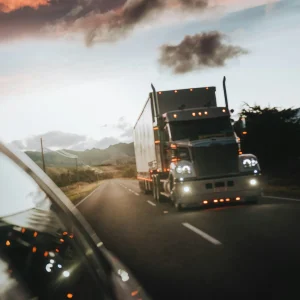 an 18 wheeler driving down a road from the point of view of a passing car
